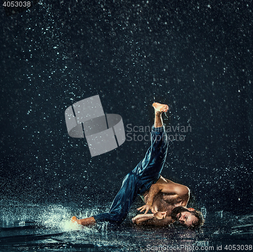 Image of The male break dancer in water.