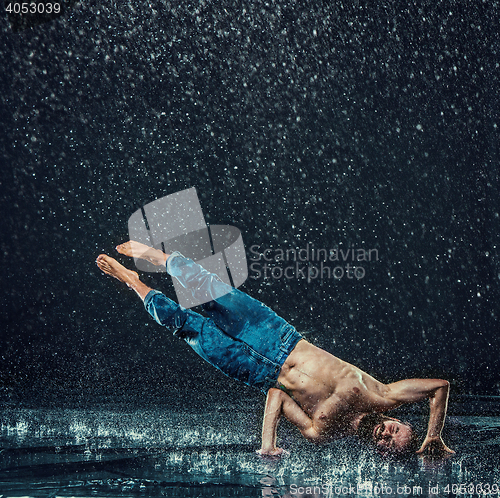 Image of The male break dancer in water.