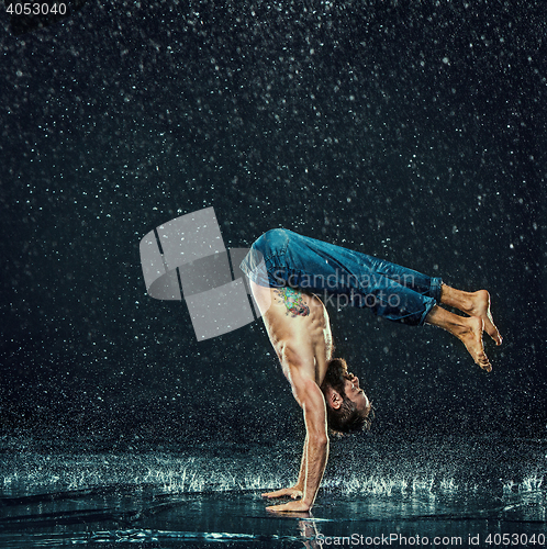 Image of The male break dancer in water.