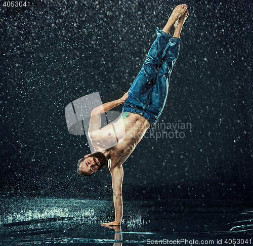 Image of The male break dancer in water.