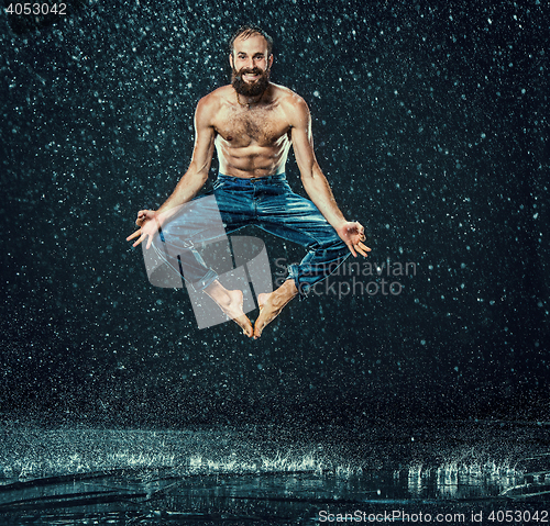 Image of The male break dancer in water.