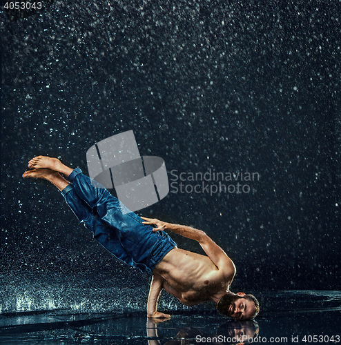 Image of The male break dancer in water.