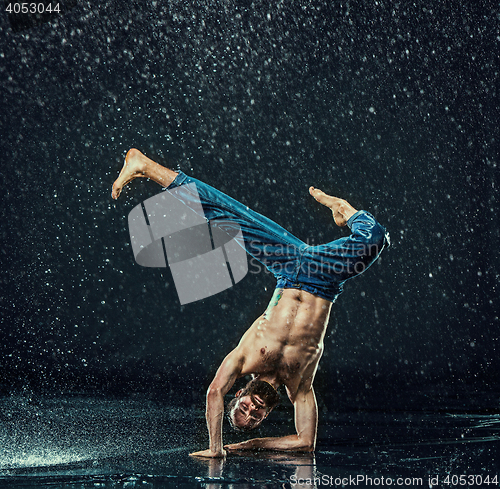 Image of The male break dancer in water.