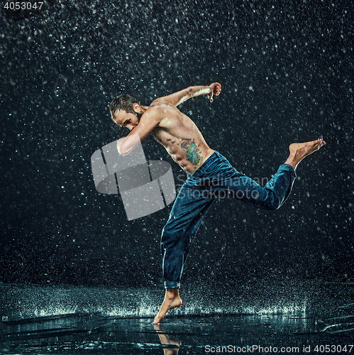 Image of The male break dancer in water.