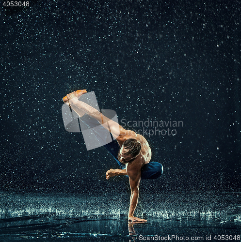 Image of The male break dancer in water.