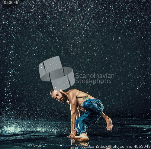 Image of The male break dancer in water.