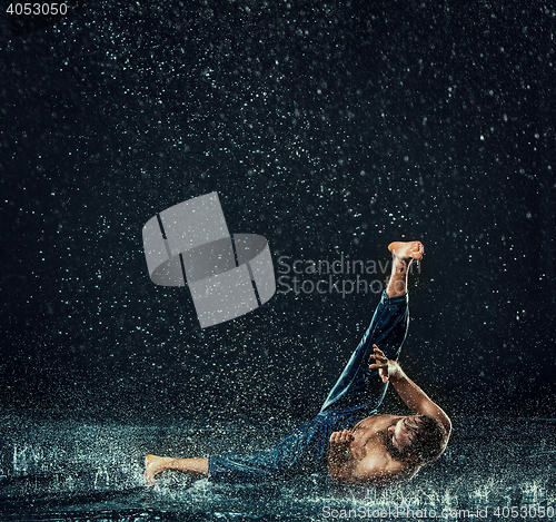 Image of The male break dancer in water.