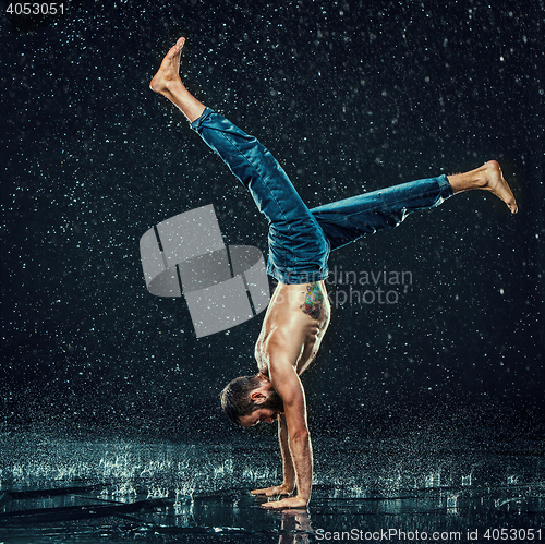 Image of The male break dancer in water.