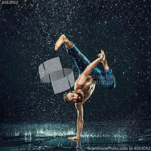 Image of The male break dancer in water.