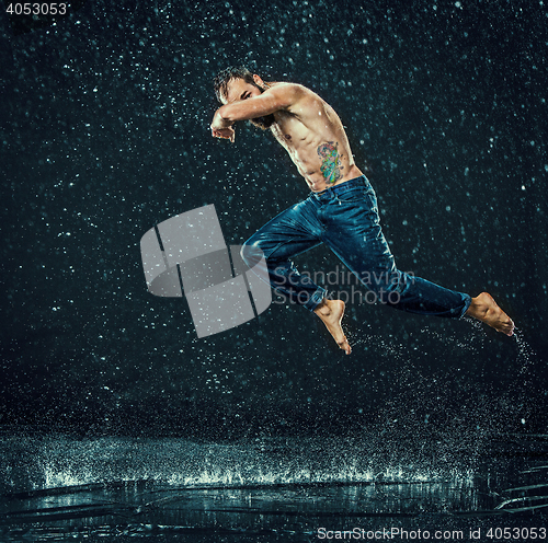 Image of The male break dancer in water.