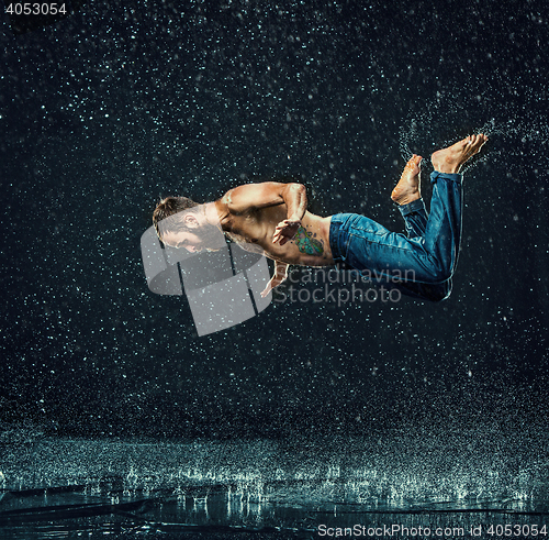 Image of The male break dancer in water.