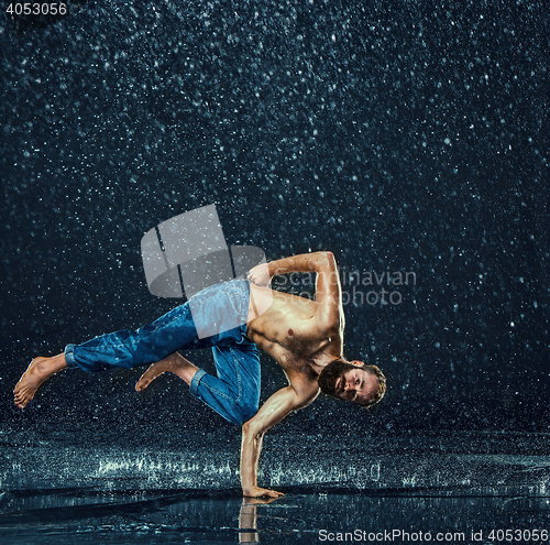 Image of The male break dancer in water.