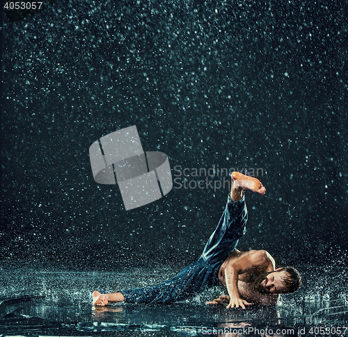 Image of The male break dancer in water.