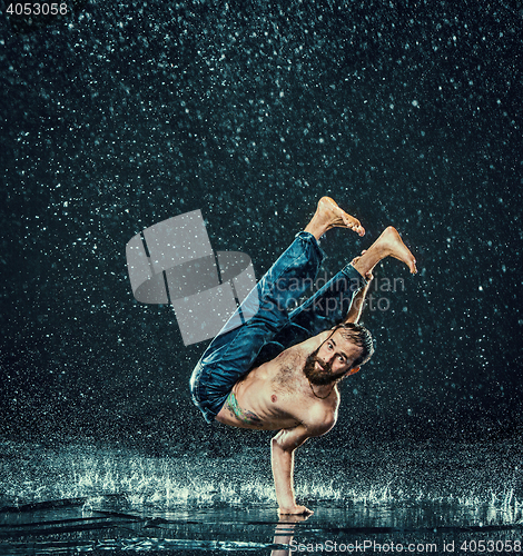 Image of The male break dancer in water.