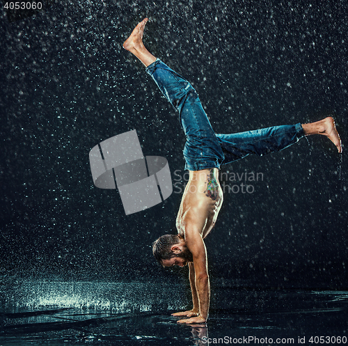 Image of The male break dancer in water.