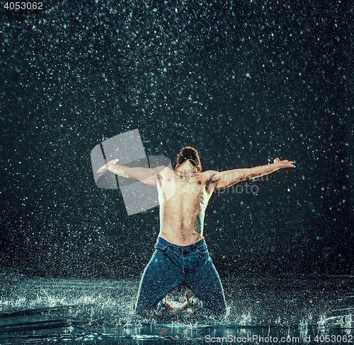 Image of The male break dancer in water.