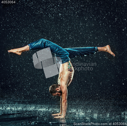 Image of The male break dancer in water.