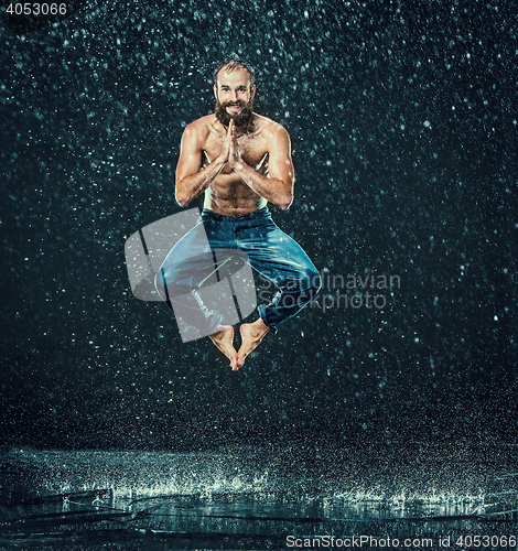 Image of The male break dancer in water.