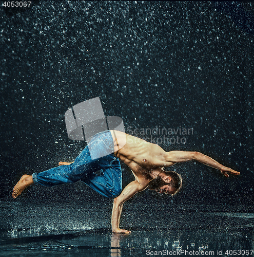 Image of The male break dancer in water.