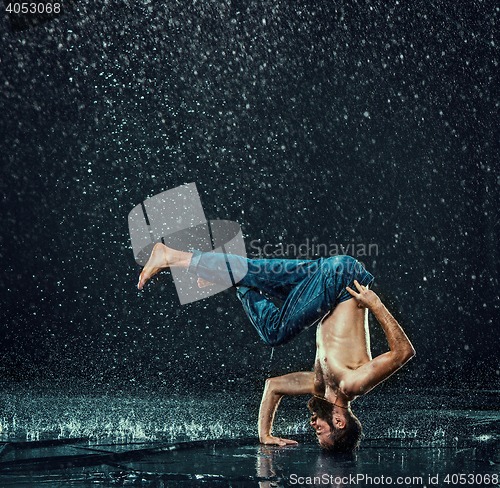 Image of The male break dancer in water.