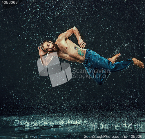 Image of The male break dancer in water.