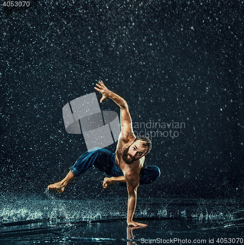 Image of The male break dancer in water.