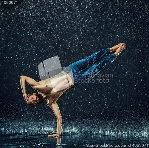 Image of The male break dancer in water.