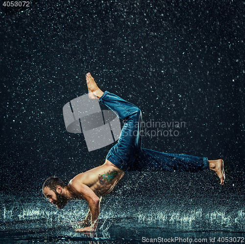 Image of The male break dancer in water.