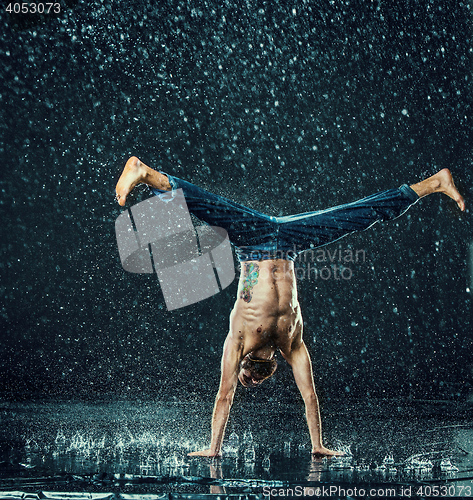 Image of The male break dancer in water.