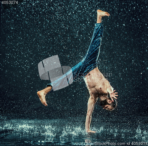 Image of The male break dancer in water.