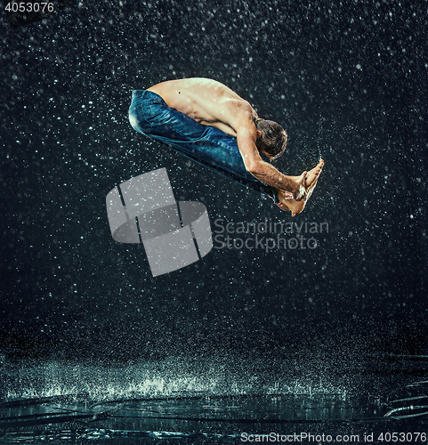 Image of The male break dancer in water.