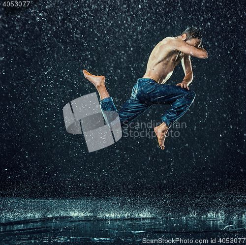 Image of The male break dancer in water.