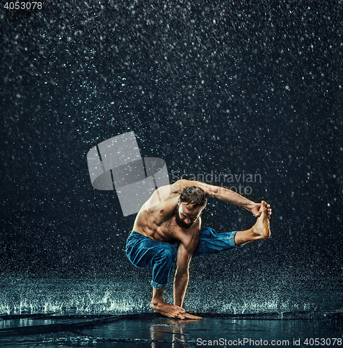 Image of The male break dancer in water.