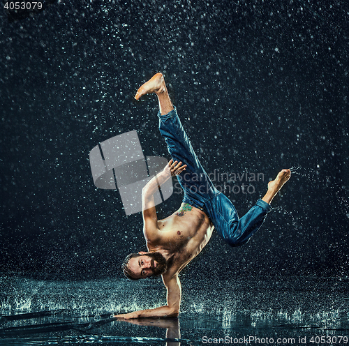 Image of The male break dancer in water.