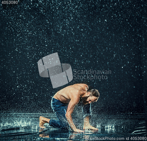 Image of The male break dancer in water.