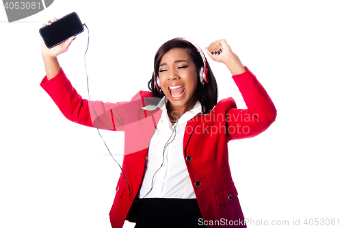 Image of Business woman jamming listening to music