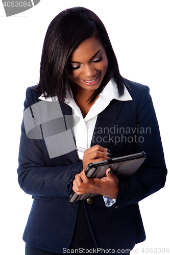 Image of Happy business woman writing on digital tablet