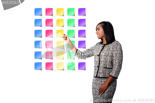 Image of Happy business woman presenting sticky notes
