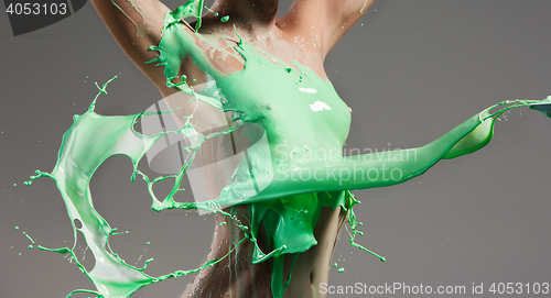 Image of The beautiful woman with green liquid paint over her body