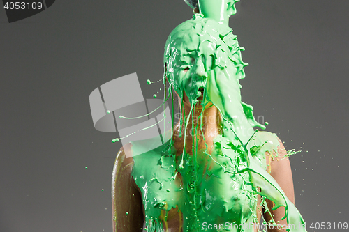 Image of The beautiful woman with green liquid paint over her body