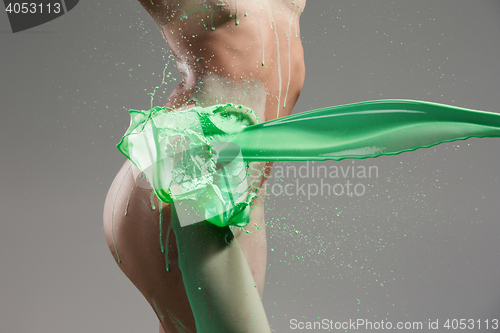 Image of The beautiful woman with green liquid paint over her body