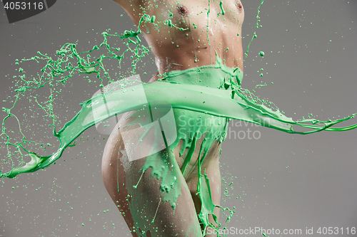 Image of The beautiful woman with green liquid paint over her body