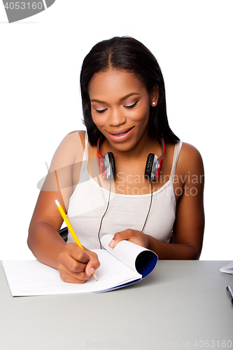 Image of Happy teenage student doing homework