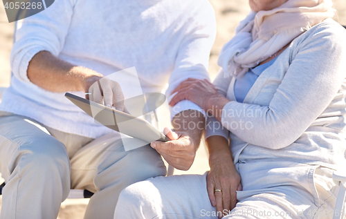 Image of close up of senior couple with tablet pc on beach