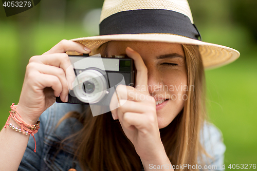 Image of close up of woman with camera shooting outdoors