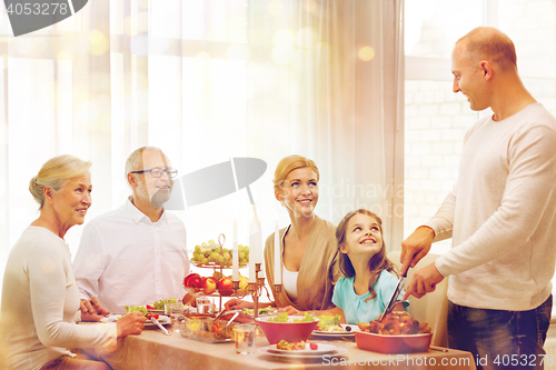 Image of smiling family having holiday dinner at home