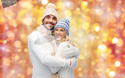 Image of smiling couple in winter clothes hugging