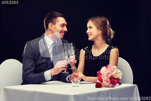 Image of couple with glasses of champagne at restaurant