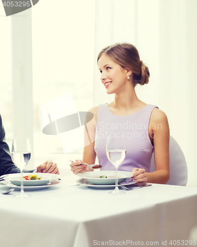 Image of young woman looking at husband or boyfriend