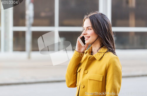 Image of smiling young woman or girl calling on smartphone